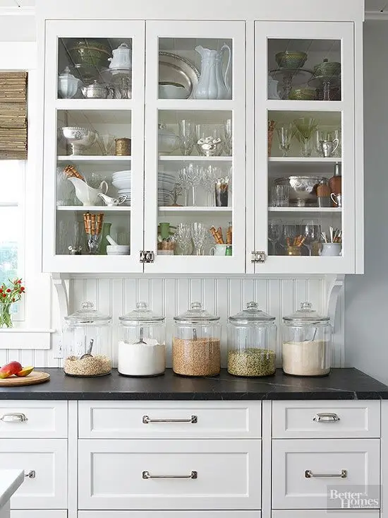 organised kitchen cabinet with glass doors