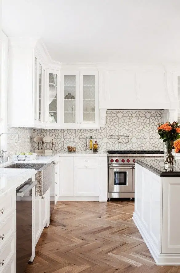 white kitchen with goemetric backsplash and wood floors