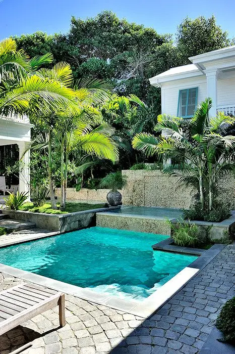 Small geometric pool with tropical gardens
