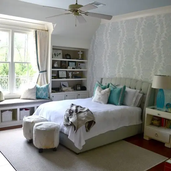 white and turquoise bedroom with a window seat