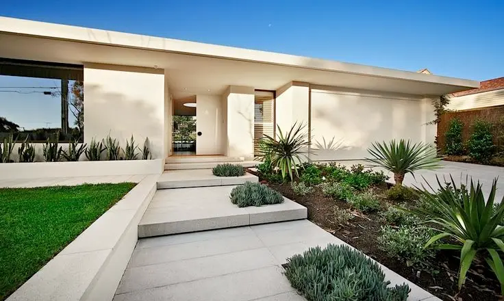 white frontage with green accent plants
