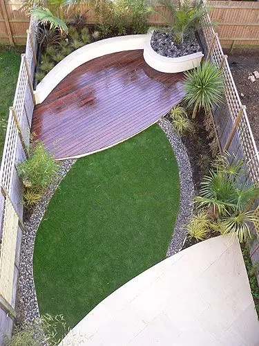 contemporary wood and grass small backyard design