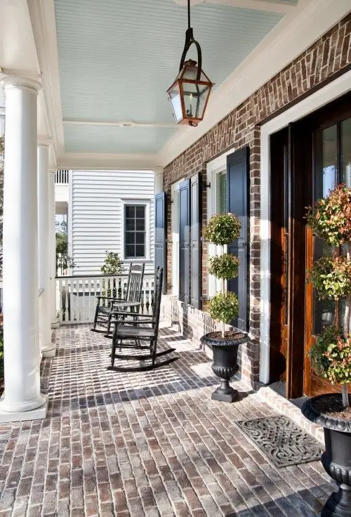 Bare Brick front verandah: Bare brick does the decorating on its own. Keep the furniture plain and let the texture carry it