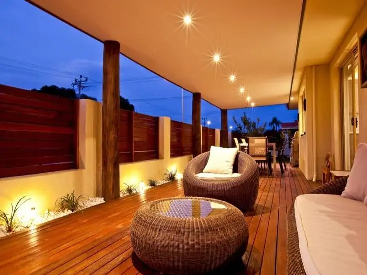 Rustic Modern front verandah: Timber columns, wicker seats, dark decking. Character without clutter