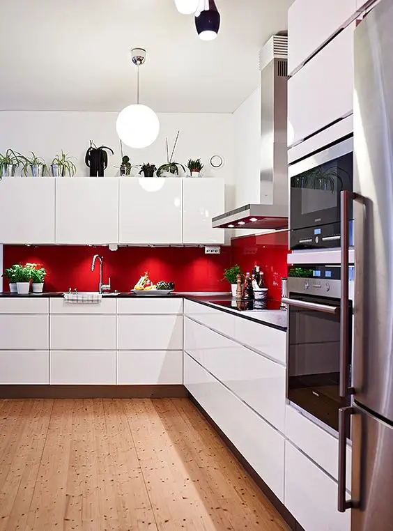 minimalist white kitchen with red backsplash