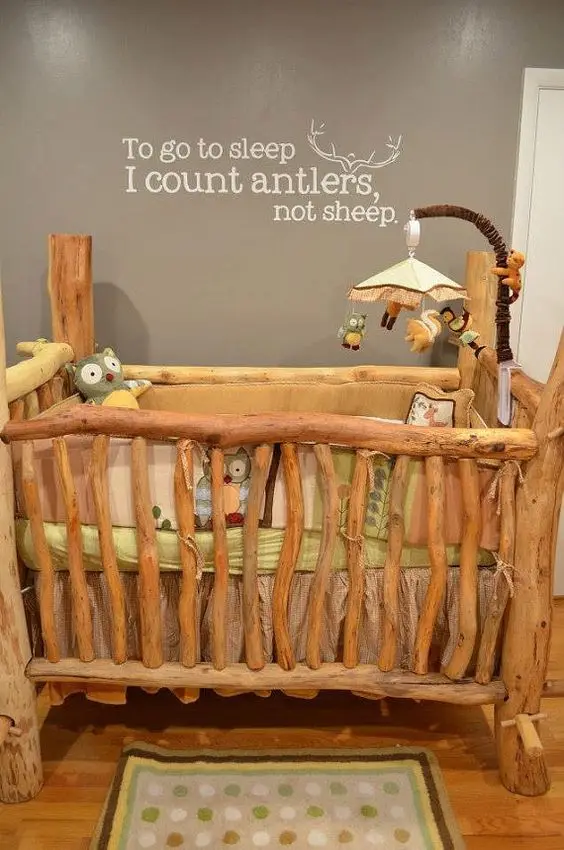 rustic log crib in nursery room
