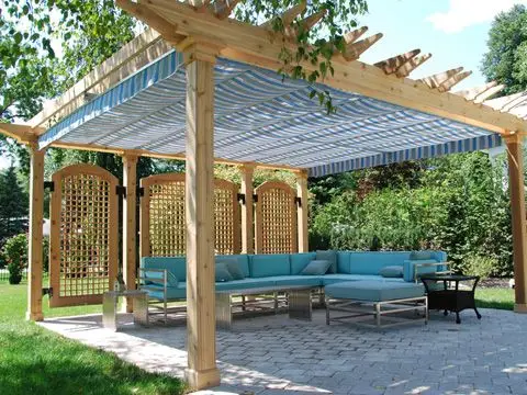 comfortable stand alone pergola with sofa and shades