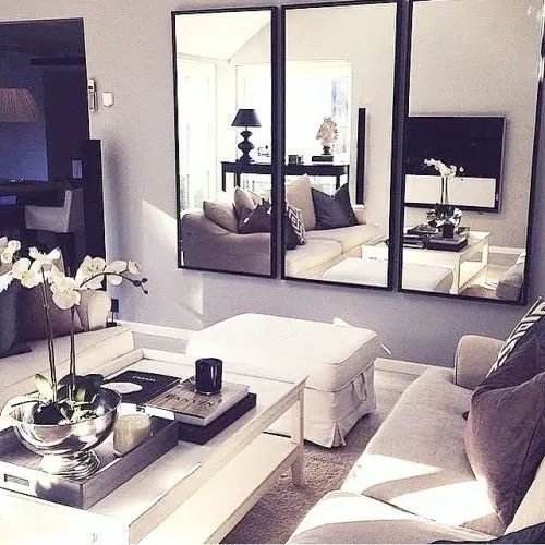 living room with wall panel mirrors