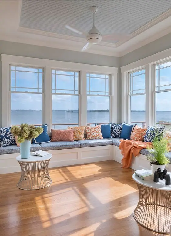 seaside living room with wide windows and built-in window seats
