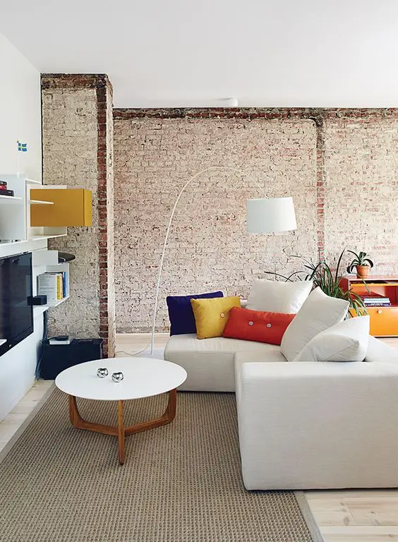 rough living room walls with exposed brick