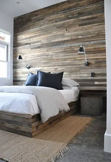 bedroom with reclaimed wood wall feature