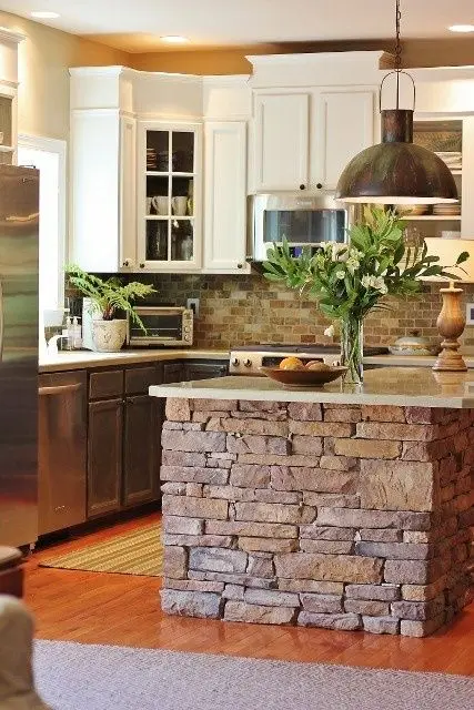 rustic kitchen with brick island and backsplash