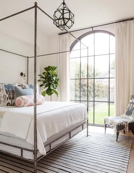 no fuss bedroom with metal canopy