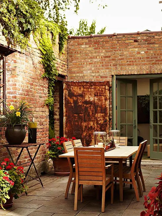 small patio with red brick walls