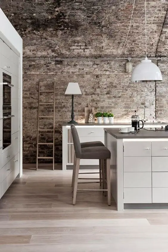 modern kitchen with aged brick wall
