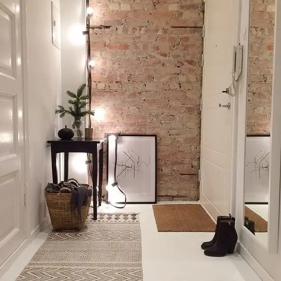 modern foyer with a brick wall