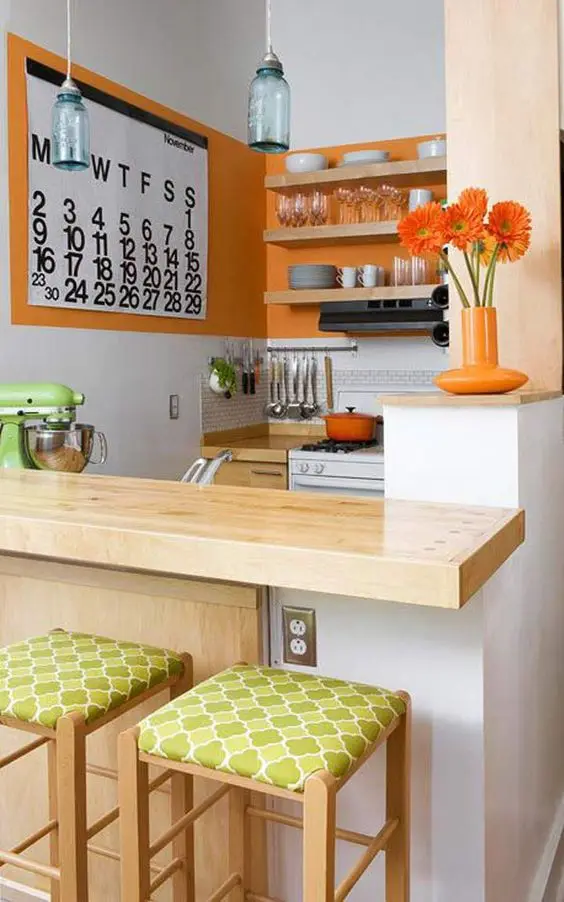 Delightful Orange small kitchen: Bright and light colour tones help small spaces pop. The delightful orange colours of this