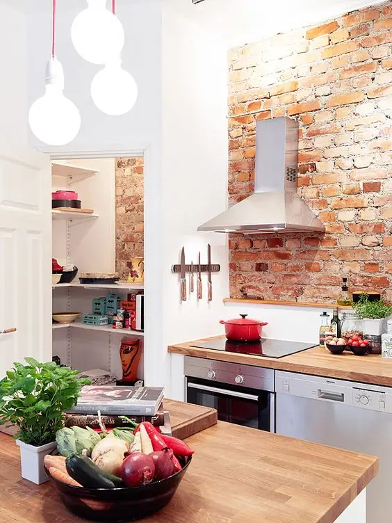 small kitchen with brick wall