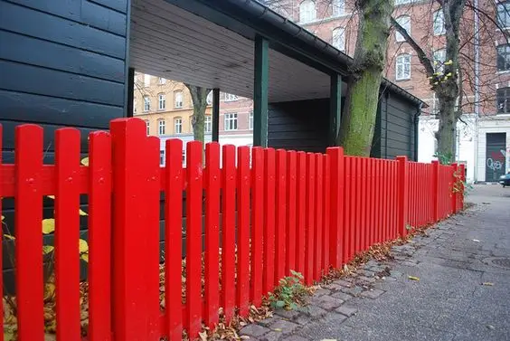 Red Picket Fence: A picket fence in deep red instead of white