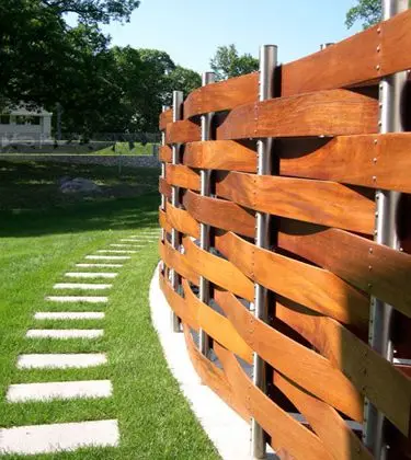 Basket Weave Fence: Boards woven over and under vertical posts, the same logic as the woven metal fence earlier