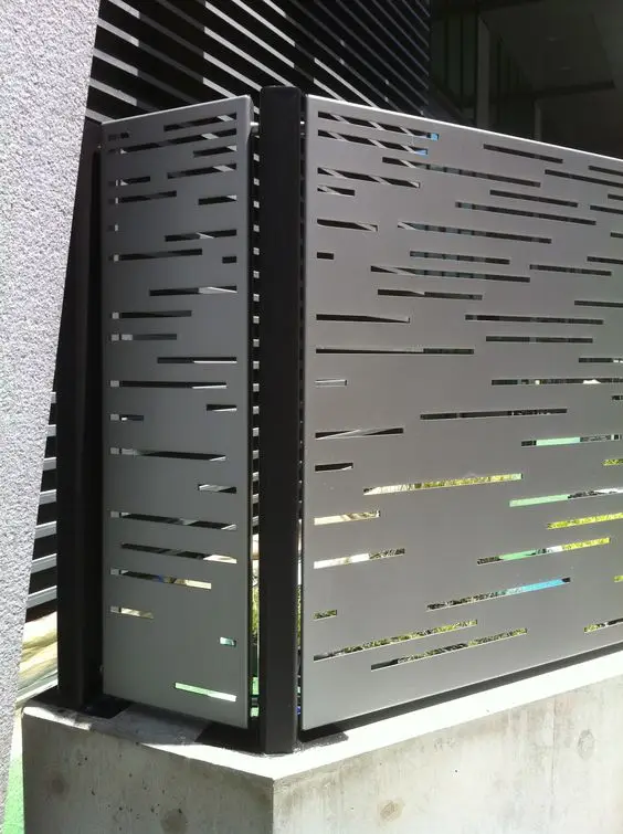 Modern Laser-Cut Steel Panels fence: Laser-cut steel panels with a precise repeating pattern