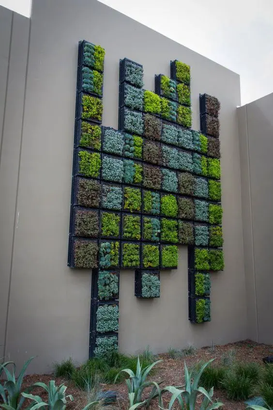 Vertiscape Garden Wall fence: Succulents in a Tetris arrangement of wall planters, colonising a plain concrete wall