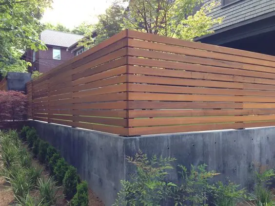 Practical Wood and Concrete Fence: Heavy base, light top is the oldest fence formula there is