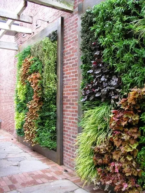 Brick and Garden Fence: A vertical garden mounted on an old brick wall