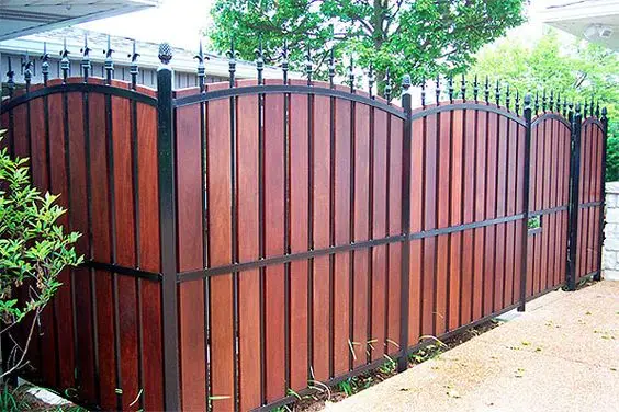 Wood and Black Iron fence: Rich timber panels between black iron frames
