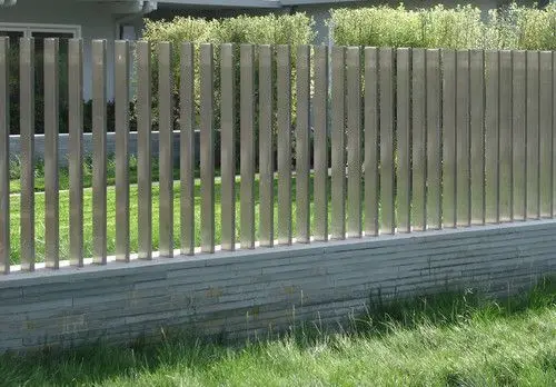Cool Grey Metal Fence: Grey metal, mid-height, sitting quietly behind the garden