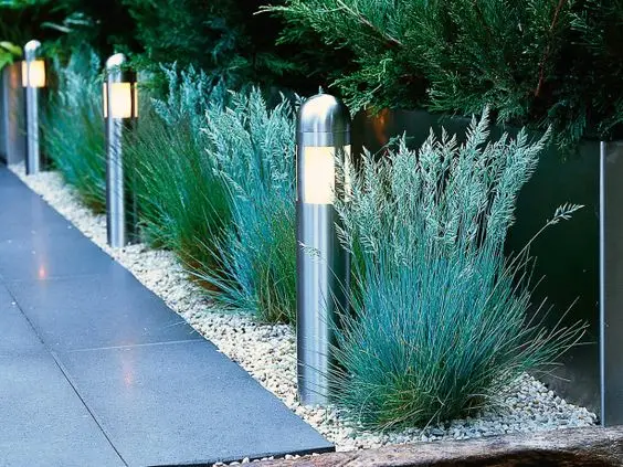Stainless Steel Light Posts fence: No fence at all, just a row of stainless bollard lights marking the boundary through planting