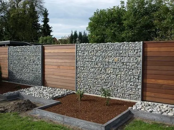 Wood Slats and Stone Wall fence: Gabion base, timber slats above