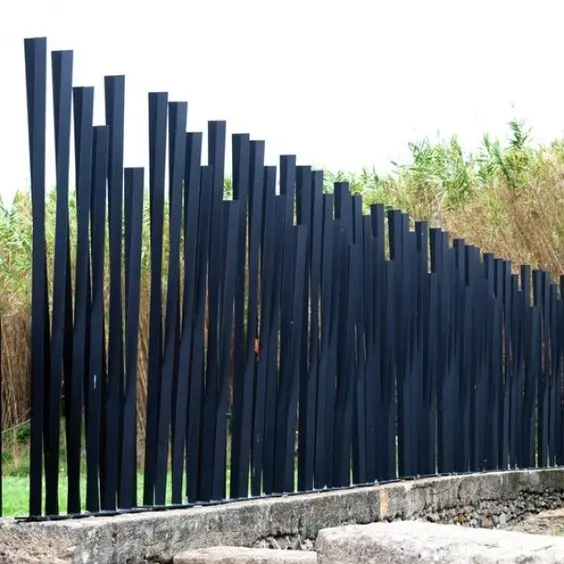 Contemporary Steel Privacy Fence: Vertical black steel blades, close-spaced, full height