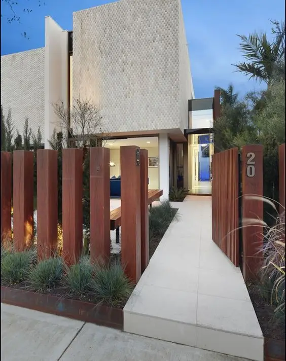 Vertical Timber Fence: Heavy vertical timbers with gaps between them