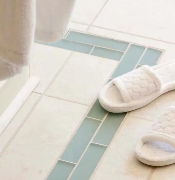 white bathroom floor with glass tile accents