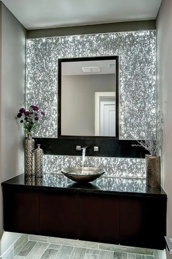 Cool Dazzle powder room: Credit the creative and strategic lighting of this powder room for its dazzling effect. The