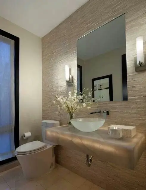 Restrained Elegance powder room: Elegant, glamorous and opulent. The unique cream rugged wall is the perfect background to
