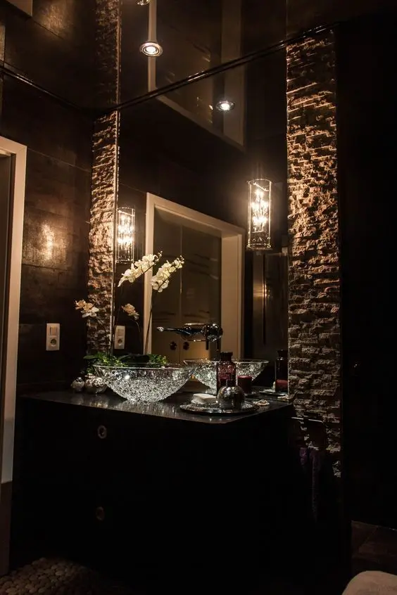 Mirrored Ceiling powder room: Go dramatic with this dark and elegant powder room design. The stone and glass interiors