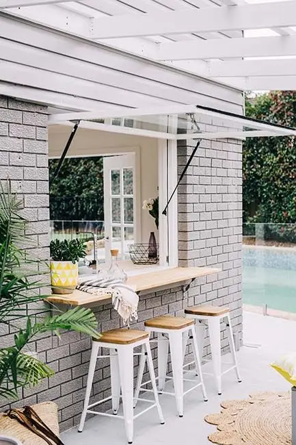 Glass Windows outdoor kitchen: This is an indoor/outdoor kitchen achieved by its wide awning glass windows. Ideal for