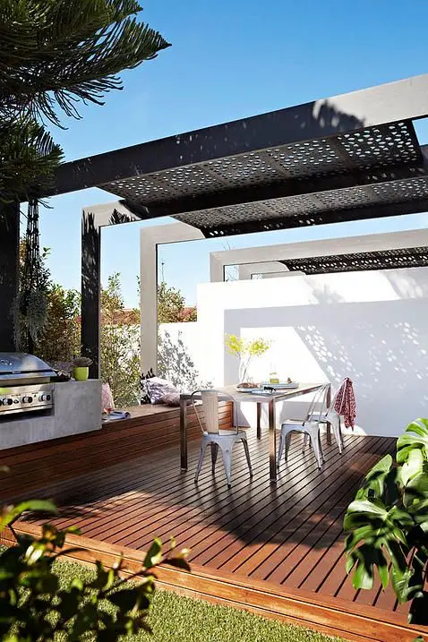 Metal-Screened Pergola outdoor kitchen: This outdoor kitchen is beautiful, generous and opulent. Wood plank flooring, metal