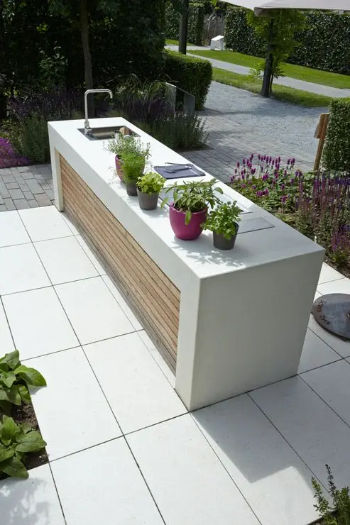 Outdoor Kitchen Island: This modern and sleek kitchen island is the entire kitchen. It includes a sink with a faucet