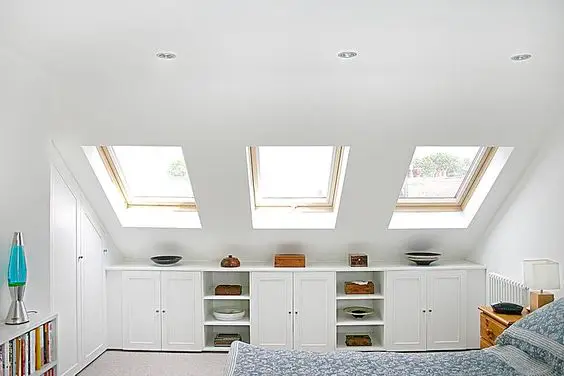 White and Skylights loft bedroom: Skylights added to your loft help open up the space and make it appear larger. The white