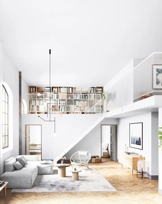 White Mezzanine loft bedroom: The all-white interiors create seamlessness within the space and help bounce off light giving