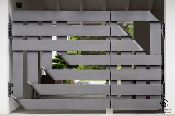 Folded Iron Stunner front gate: Iron plates folded so the surface catches light differently through the day