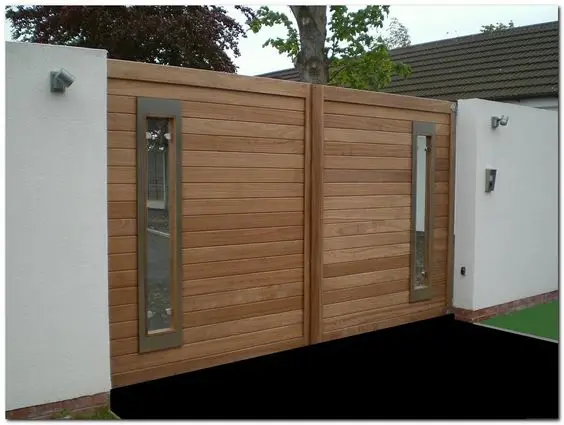 Viewing Slots front gate: Bare timber, concrete and glass, with slots at eye height so you can see who's buzzing