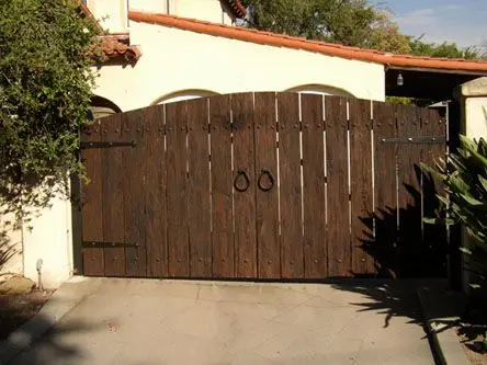 Tuscan Barndoors front gate: Barn-style double doors with ring handles and strap hinges