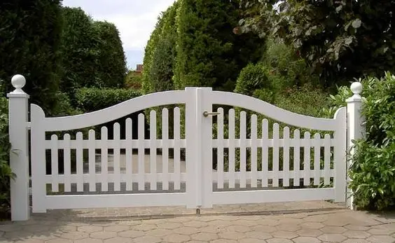 Cottage White Picket Fence Gate: The white picket gate still does what it has always done: frames a green garden and makes the whole