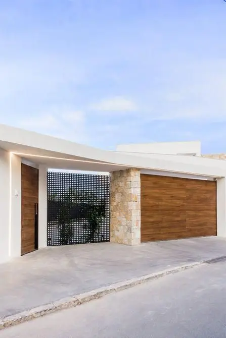 Wood and Stone front gate: Timber, stone and concrete stacked into a single entry, with a steel mesh panel worked in