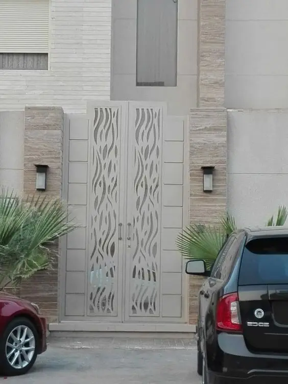 White Laser Cut front gate: A laser-cut pattern in white against plain rendered walls
