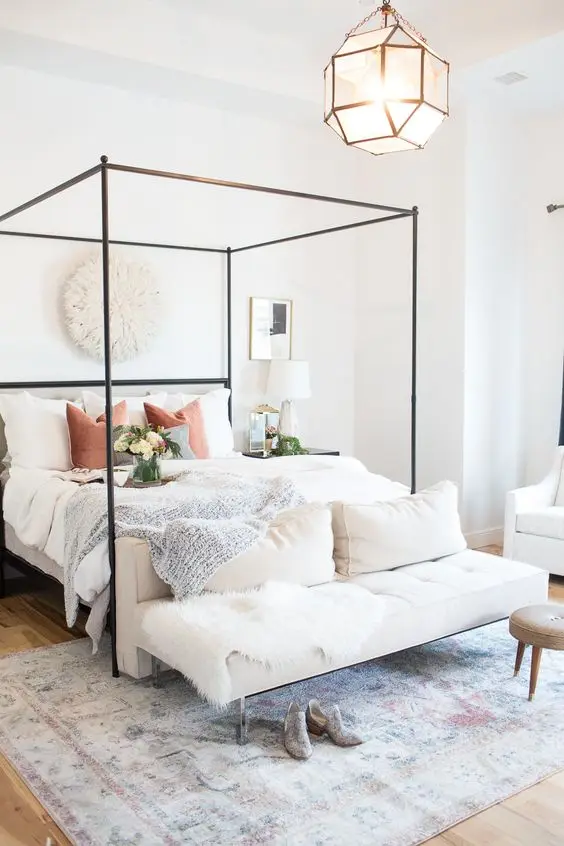 Iron Canopy Bed bedroom: A chic and modern bedroom with a hint of posh. The white bedroom keeps décor to a minimum, just a